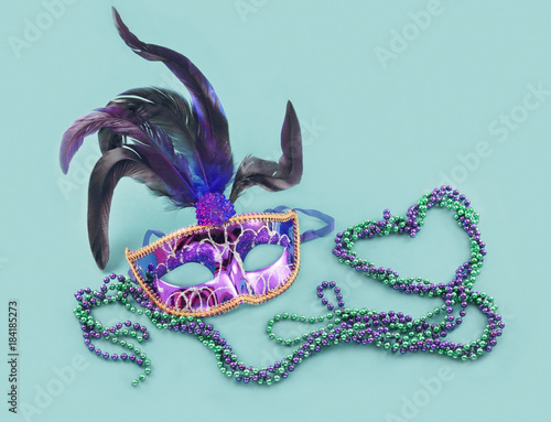 carnival mask and beads on a blue background