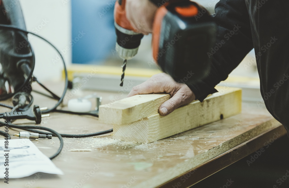 Master carpenter working on woodwork using electric tools Master carpenter working on woodwork using electric tools