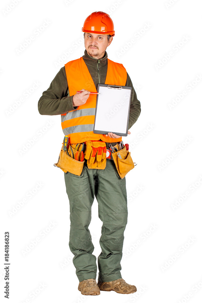 male builder or manual worker in helmet holding a clipboard and pointing with a pen over white wall background. male builder or manual worker in helmet holding a clipboard and pointing with a pen over white wall background.
