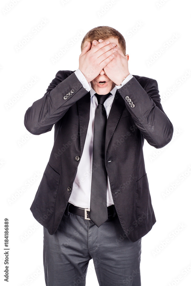 portrait young businessman covering his eyes with his hand. emotions, facial expressions, feelings, body language, signs. image on a white studio background. portrait young businessman covering his eyes with his hand. emotions, facial expressions, feelings, body language, signs. image on a white studio background.
