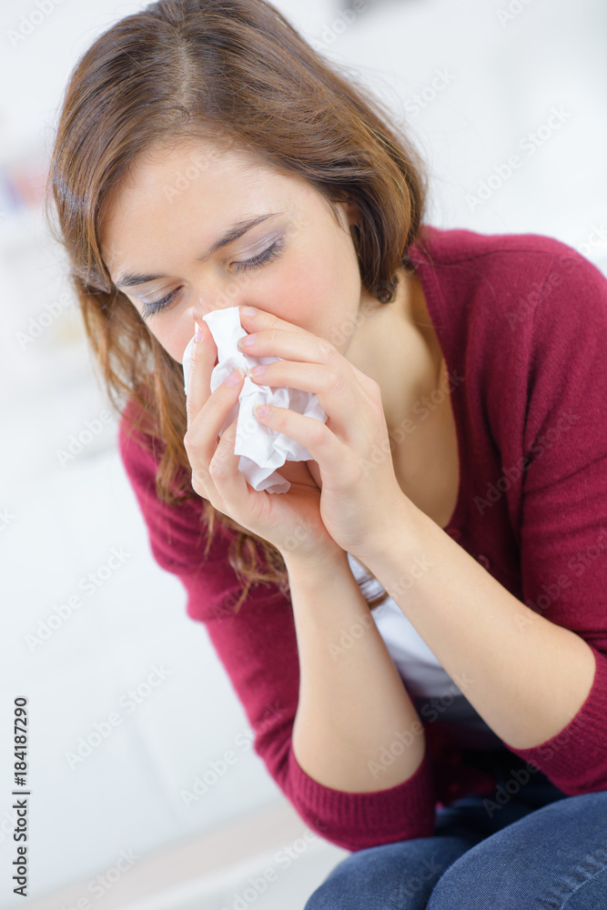 unhappy woman with paper napkin blowing nose unhappy woman with paper napkin blowing nose