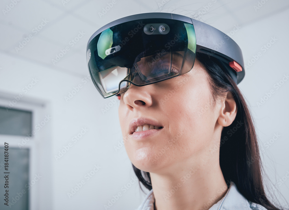 Woman wearing augmented reality goggles. Woman wearing augmented reality goggles.