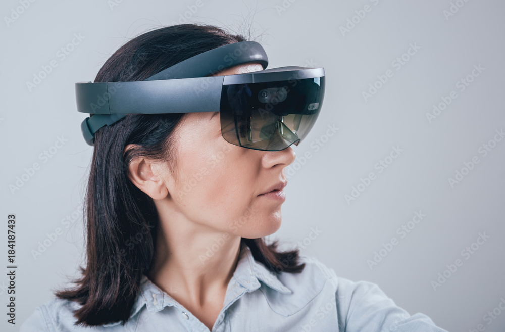 Woman wearing augmented reality goggles. Woman wearing augmented reality goggles.