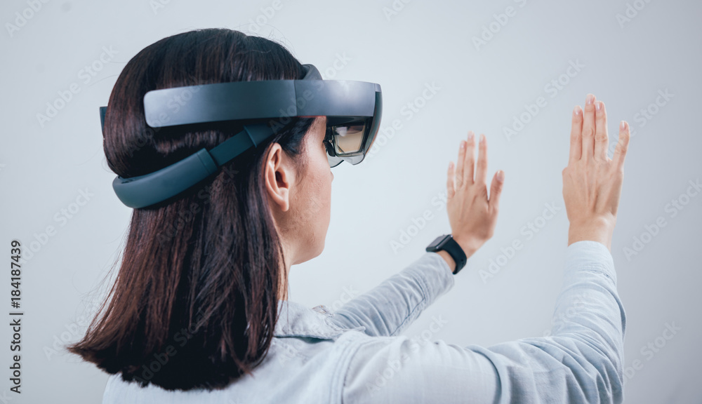 Woman wearing augmented reality goggles. Woman wearing augmented reality goggles.