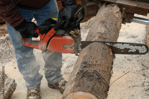 Cutting through a log with a chainsaw 2