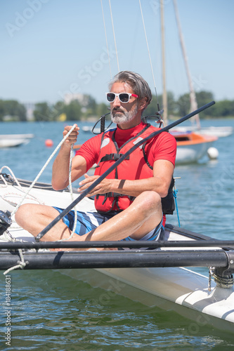 senior man on catamaran