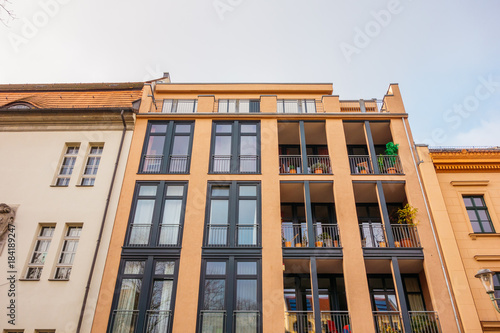 orange apartment building with steel balcony
