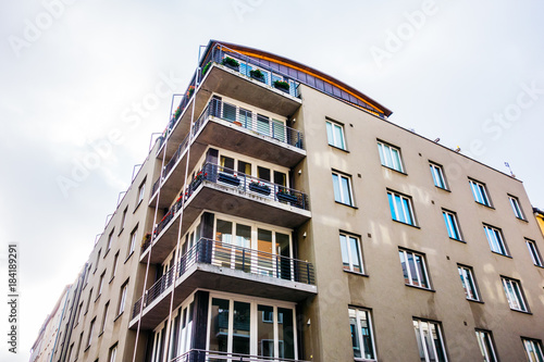 old brown apartment building with corner balcony