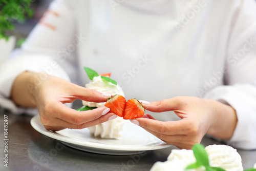 Busy chef at work in the restaurant kitchen photo