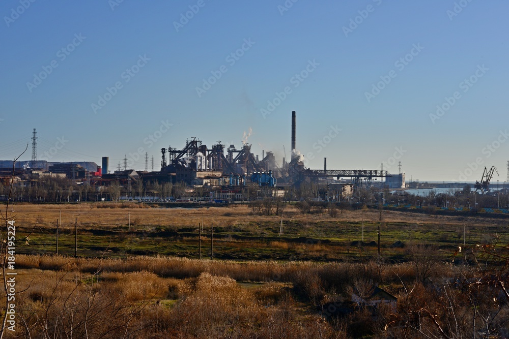 Cooling towers on the background of production and residential buildings. Aerial view. Cooling towers on the background of production and residential buildings. Aerial view.