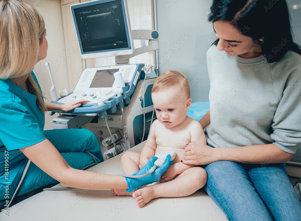 Doctor and little boy patient. Ultrasound equipment. Diagnostics. Sonography. Doctor and little boy patient. Ultrasound equipment. Diagnostics. Sonography.