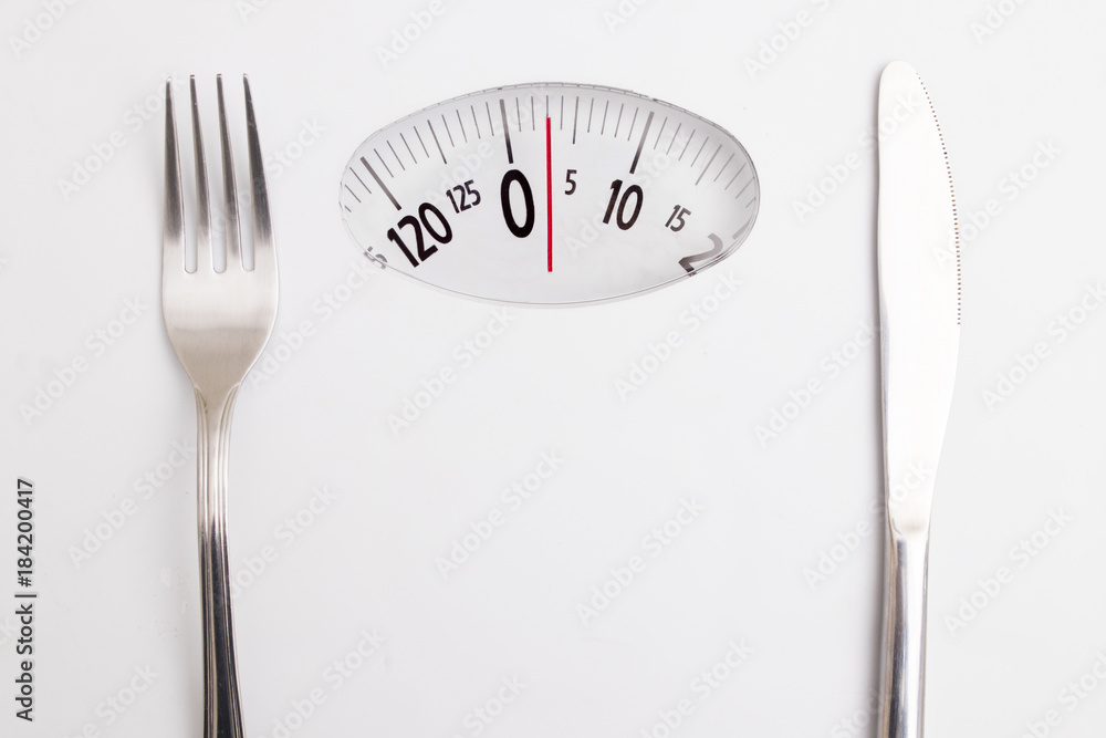 Naklejka premium scale with cover and knife, concept of diet and lose weight