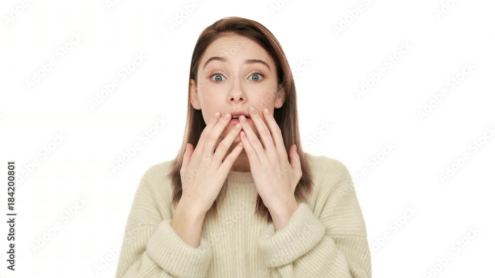 Closeup portrait of young caucasian woman being shocked with unexpected news screaming in anxiety covering opened mouth with hands isolated over white background. Concept of emotions Closeup portrait of young caucasian woman being shocked with unexpected news screaming in anxiety covering opened mouth with hands isolated over white background. Concept of emotions