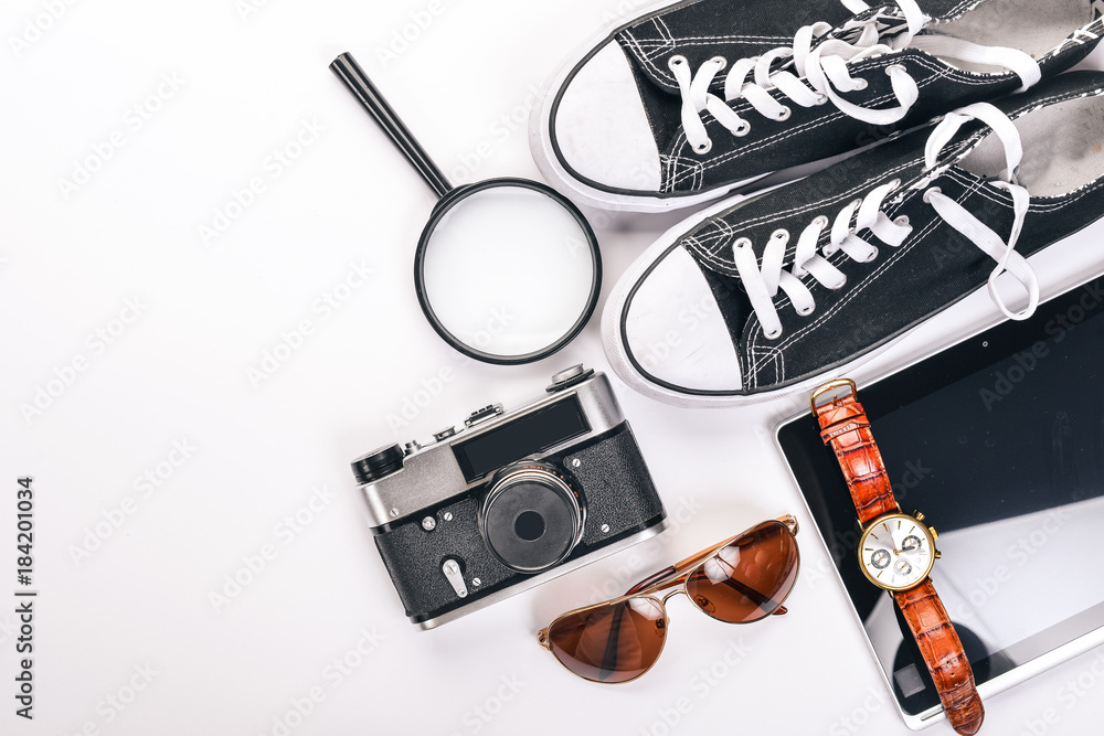 Travel, camera, sneakers, US dollars, phone, watches. Top view. Free space for text. Travel, camera, sneakers, US dollars, phone, watches. Top view. Free space for text.