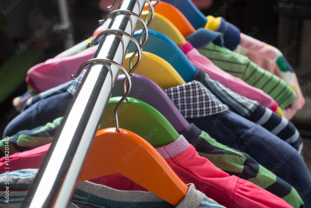 Hangers with colourful clothes isolated on white background Hangers with colourful clothes isolated on white background