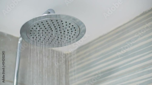 Home shower head closeup, raindrop flow model, spilling water