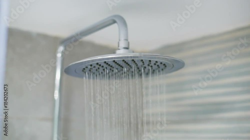 Home shower head closeup, raindrop flow model, spilling water