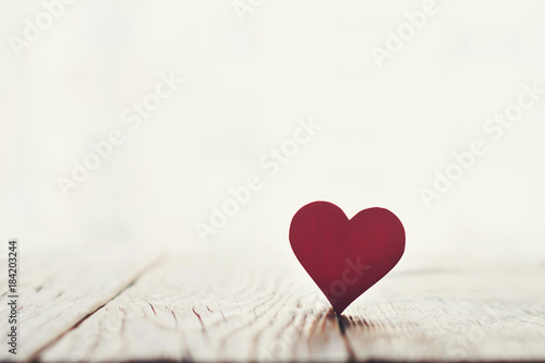 Valentine day card - red heart on a wooden texture