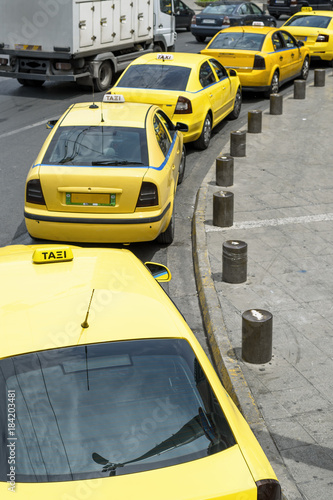 Taxis line up waiting for a customer on the streets of Athens