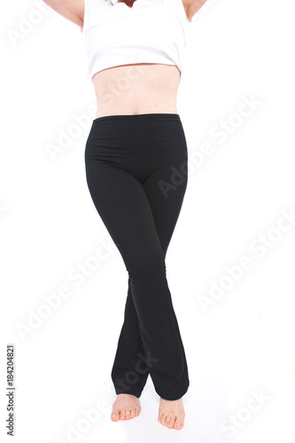 Young woman wearing black boot cut leggings isolated on white background