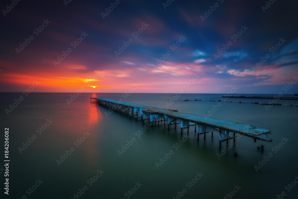 Fototapeta premium Old broken bridge in the sea, long exposure