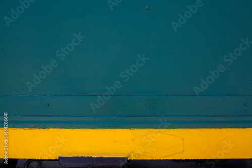 Paint smudges on the surface. The green background. Yellow lines on a green. Metal painted green. Horizontal parallel lines