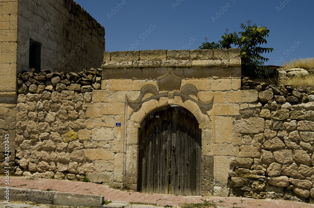 OId door in a wall with bricks in the South Cappadocia Valley.