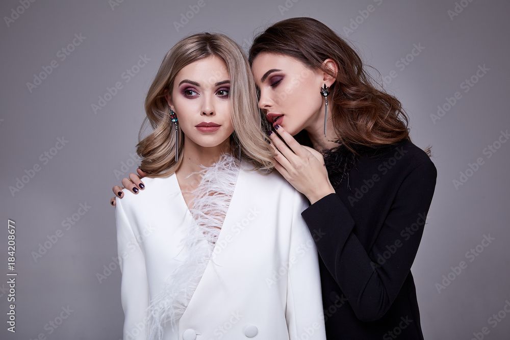 Portrait two sexy pretty beautiful woman fashion style clothes model  perfect face jacket silk curly brunette blond hair lux dress code jewelry  accessory beauty salon party makeup cosmetic girlfriend. Stock Photo