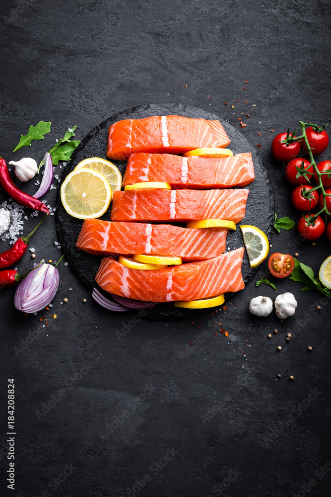 Fresh raw salmon red fish fillet on black background. Top view Fresh raw salmon red fish fillet on black background. Top view