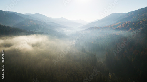 Aerial view of the mountains with a morning fog © Oleksii Nykonchuk