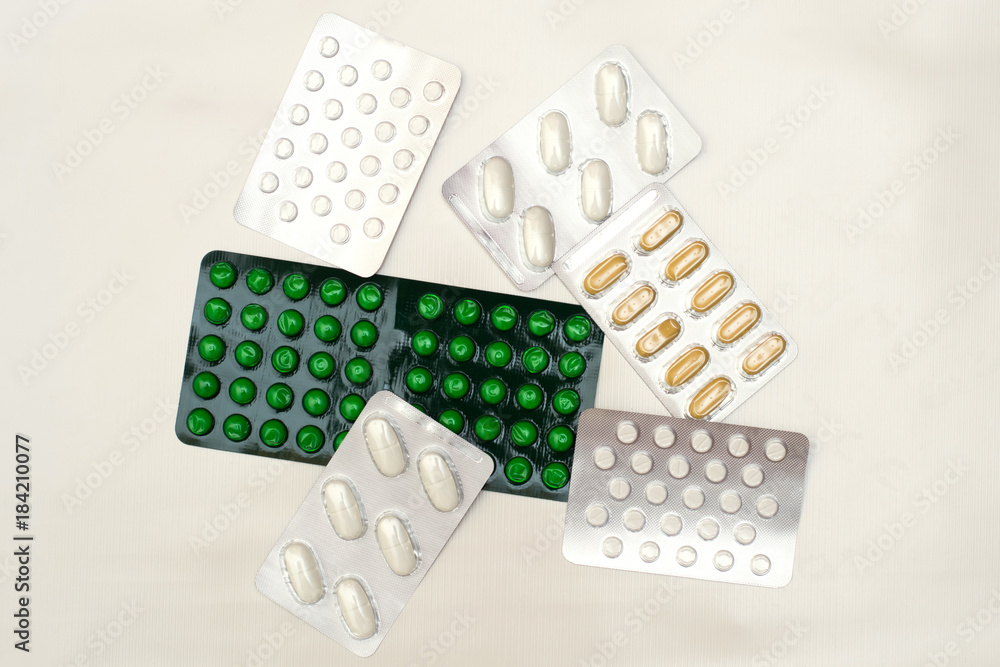Different kinds of tablets in blasters on a light background Different kinds of tablets in blasters on a light background