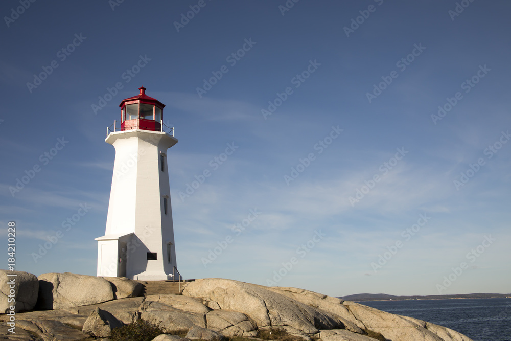 Peggys Cove Lighthouse, Nova Scotia, Canada against blue skies Peggys Cove Lighthouse, Nova Scotia, Canada against blue skies