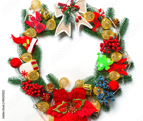 Christmas wreath with decorations, branch of Xmas tree on white background. A symbol of winter and new year holidays. Free space