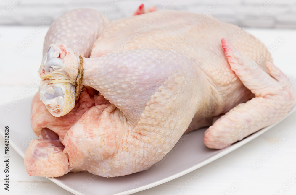 Raw chicken on white table Raw chicken on white table