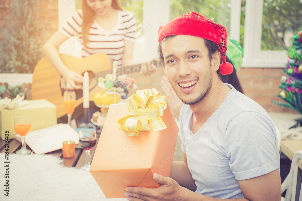 Asian people man giving gift box and celebration at party outdoor. group of friends social event with birthday achievement, festive concept. Asian people man giving gift box and celebration at party outdoor. group of friends social event with birthday achievement, festive concept.