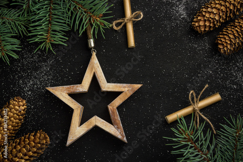 christmas background. star and spruce branches on a black