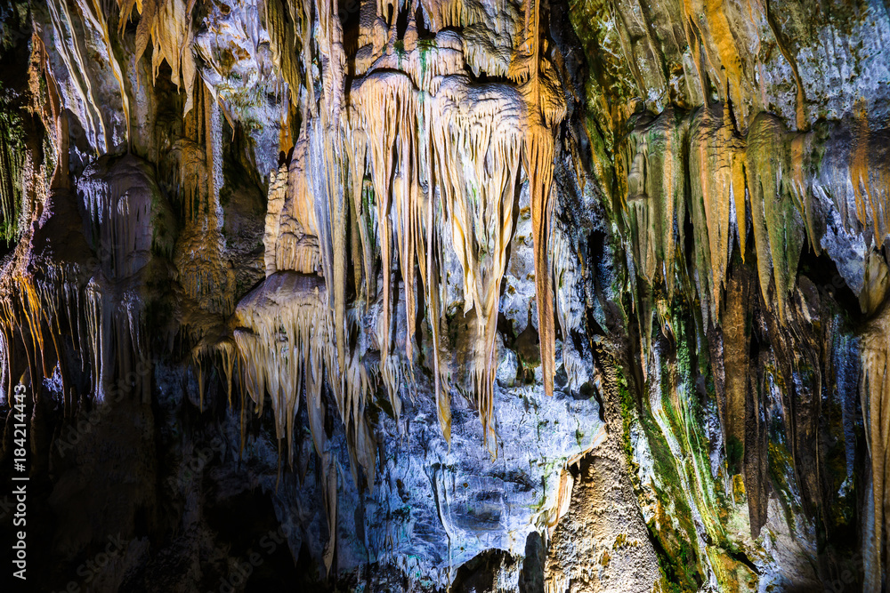 Postojna cave, Slovenia. Formations inside cave with stalactites and stalagmites. Low light image.