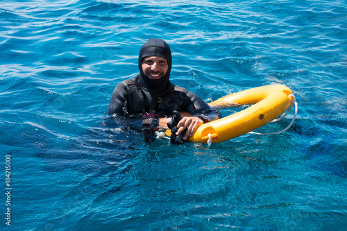 snorkeling and scuba diving in  the Red sea. Beautiful sexy diver on the background of azure sea. Water rescue operation © Viktoria