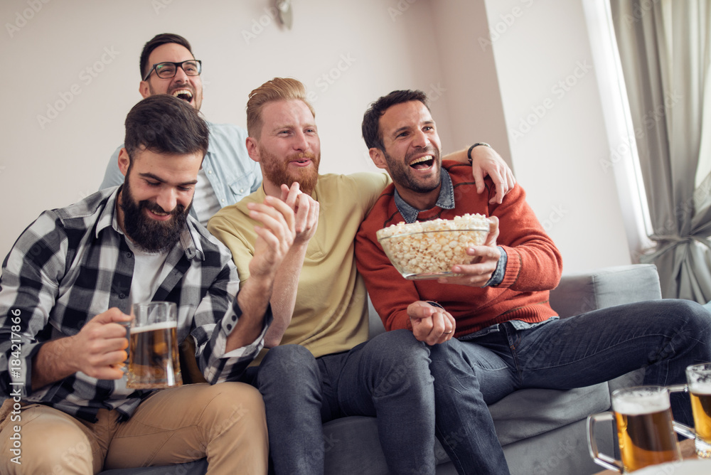 Group of friends watching football game together Group of friends watching football game together