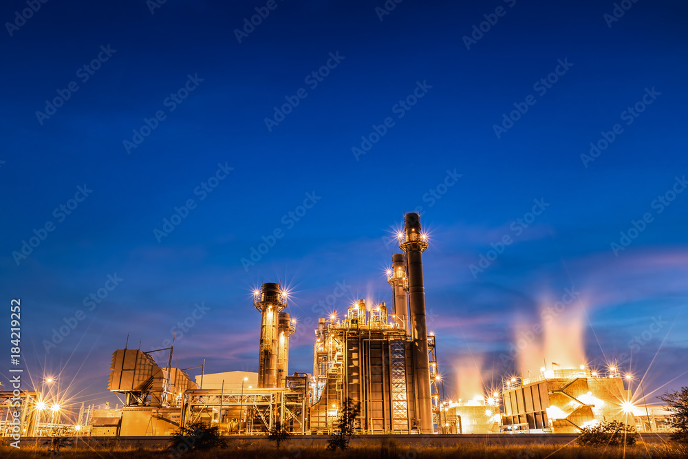 Gas combine electrical power plant at dusk with blue sky is support all factory in industrial estate
