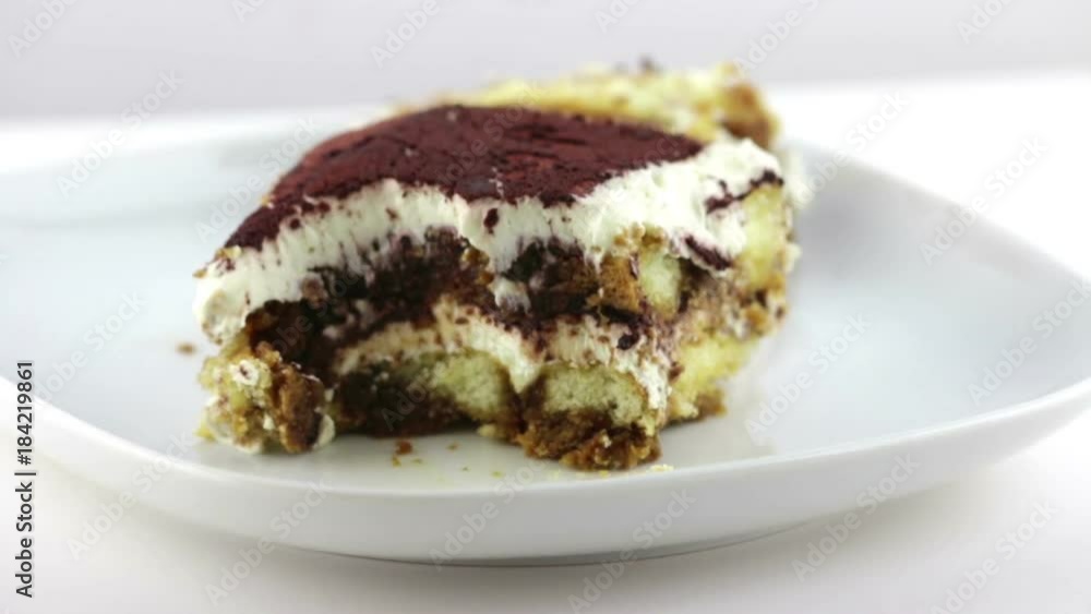 man use the spoon for eat delicious homemade tiramisu cake traditional Italian dessert on white background, nutrition health-care concept man use the spoon for eat delicious homemade tiramisu cake traditional Italian dessert on white background, nutrition health-care concept