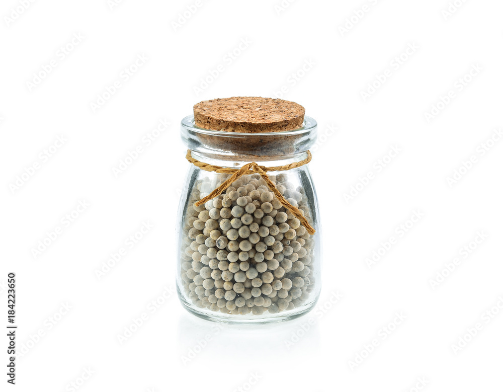 Pepper seeds in glass bottles on white background Pepper seeds in glass bottles on white background