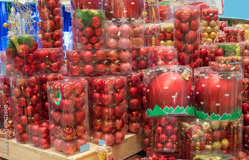 New Year and Christmas shopping. Shelf with red Christmas tree decoration balls. difficult decision. Various choice photo