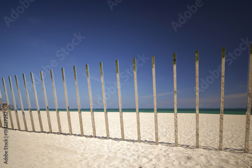 Metal stainless steel poles in the sand