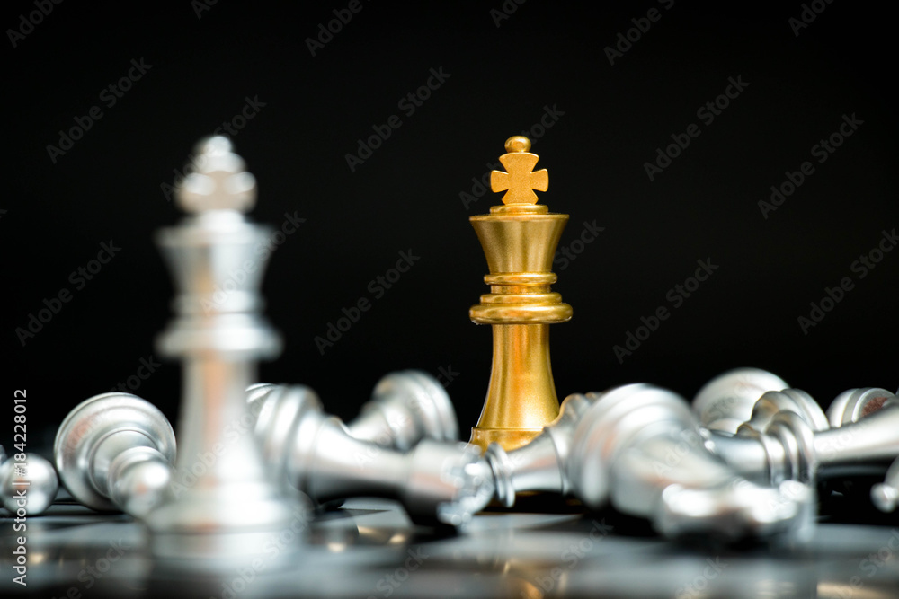 Gold king in chess game face with the another silver team on black background (Concept for company strategy, business victory or decision) Gold king in chess game face with the another silver team on black background (Concept for company strategy, business victory or decision)