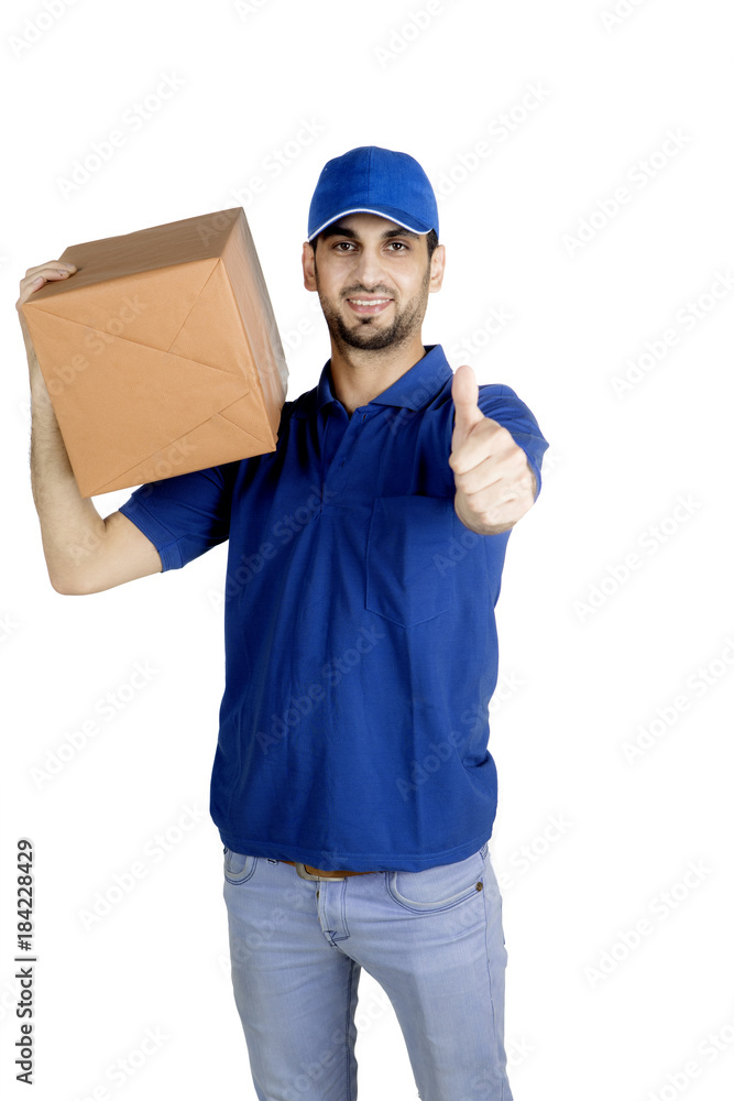 Delivery man showing thumb up on studio Delivery man showing thumb up on studio