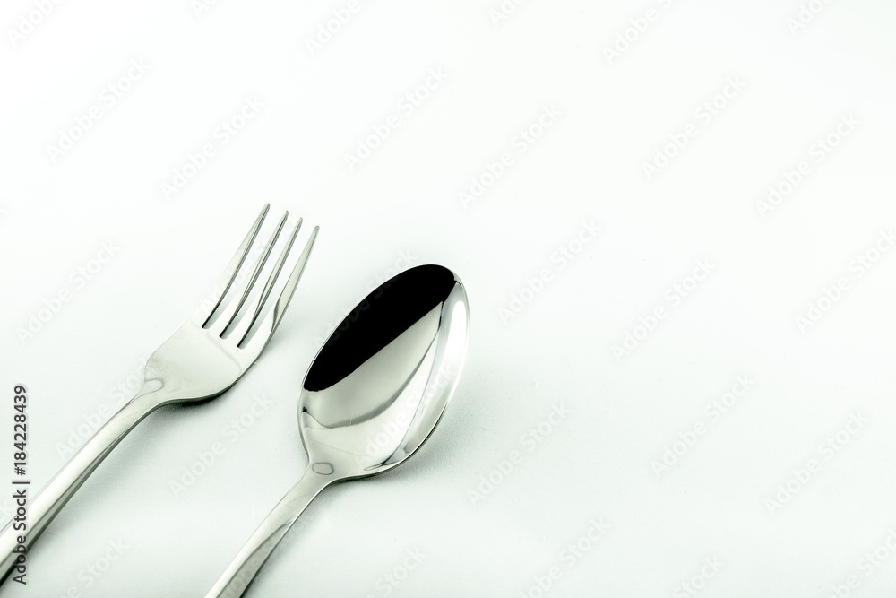 Spoon and fork isolated on white background. Used in advertising and design. Spoon and fork isolated on white background. Used in advertising and design.