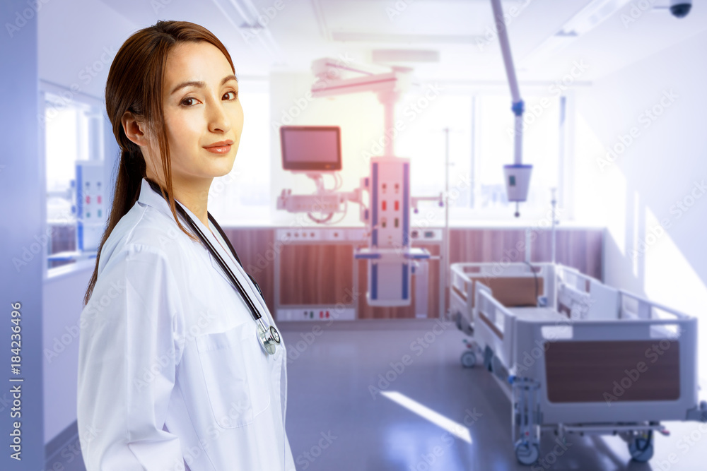 Female doctor standing in hospital room. Female doctor standing in hospital room.