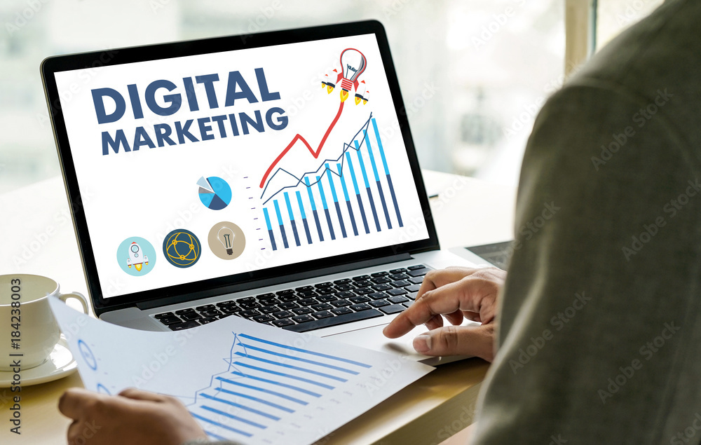 DIGITAL MARKETING new startup project MILLENNIALS Business team hands at work with financial reports and a laptop DIGITAL MARKETING new startup project MILLENNIALS Business team hands at work with financial reports and a laptop