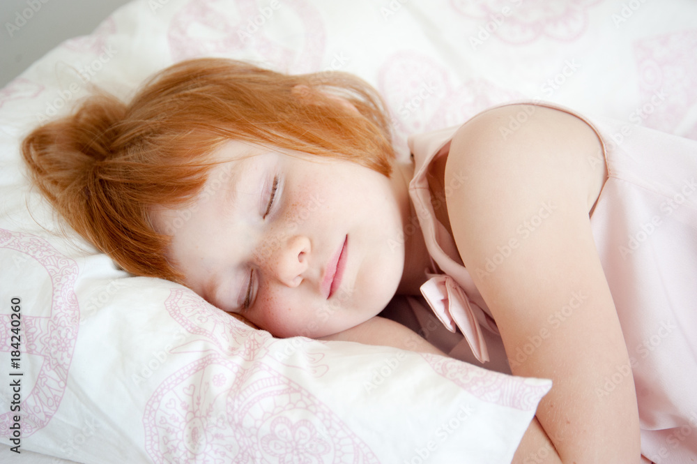 Red-haired girl pretending to be asleep